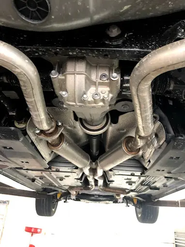 Underside of a car showing the exhaust pipes and mufflers