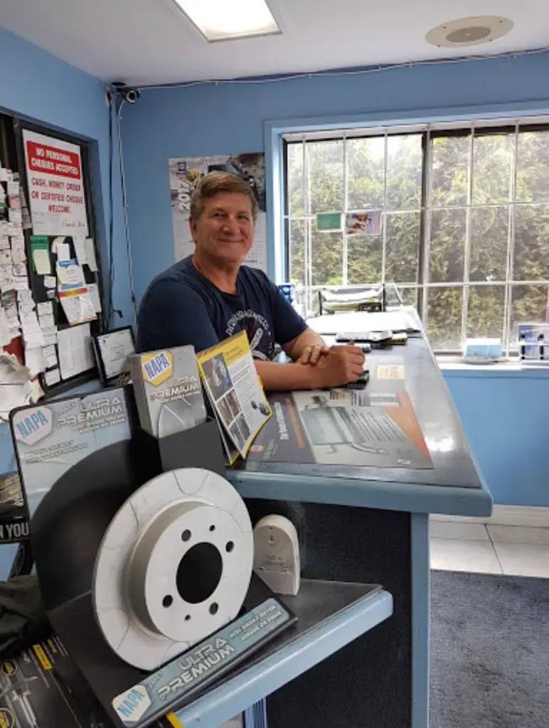 KMF Automotive team member at the service desk with new brake rotors