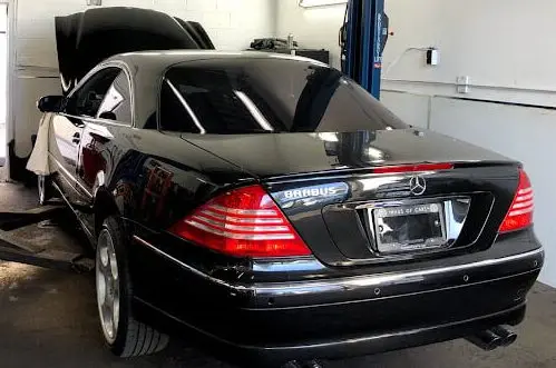 Black Mercedes-Benz on the alignment rack at KMF Automotive